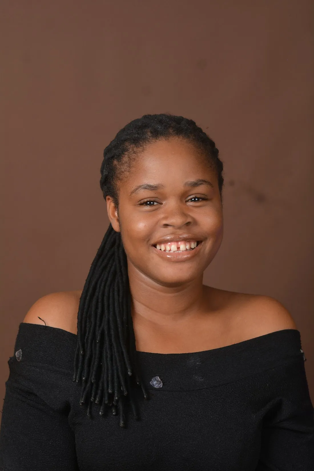 Smiling young woman with long braids
