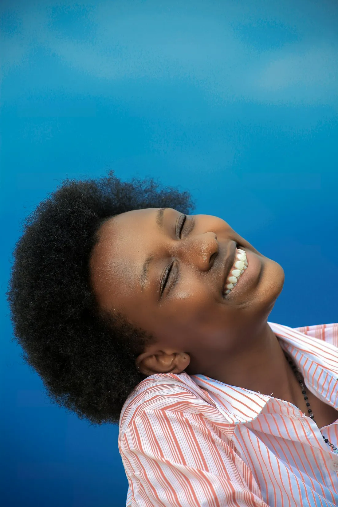 Young woman laughing with her head tilted back